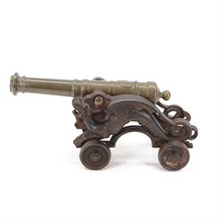 Victorian brass and cast iron model of a cannon, with tapering multiple banded barrel, the...