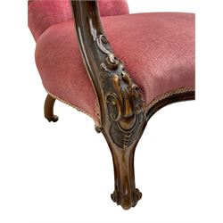 Victorian carved walnut open armchair, foliate carved cresting rail over butted back and sprung seat, upholstered in pink velvet scrolled arm terminals with moulded scrolling vines terminating to cabriole supports and ceramic castors