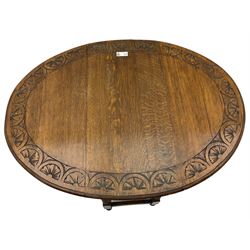 Early 20th century oak dining table, moulded oval drop-leaf top carved with lunettes, gate-leg action base, on spiral turned supports
