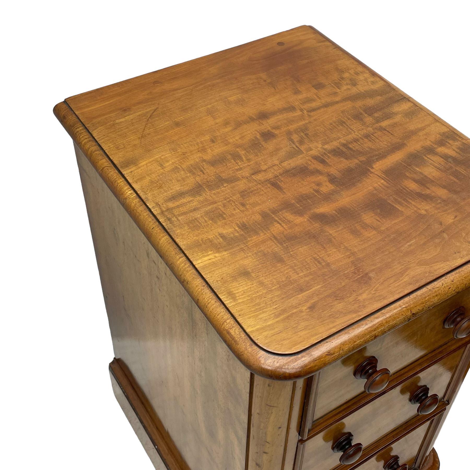 Pair of Victorian figured mahogany pedestal chests, rectangular form with rounded front corners, moulded top over three drawers with applied mouldings and turned handles, on moulded plinth base