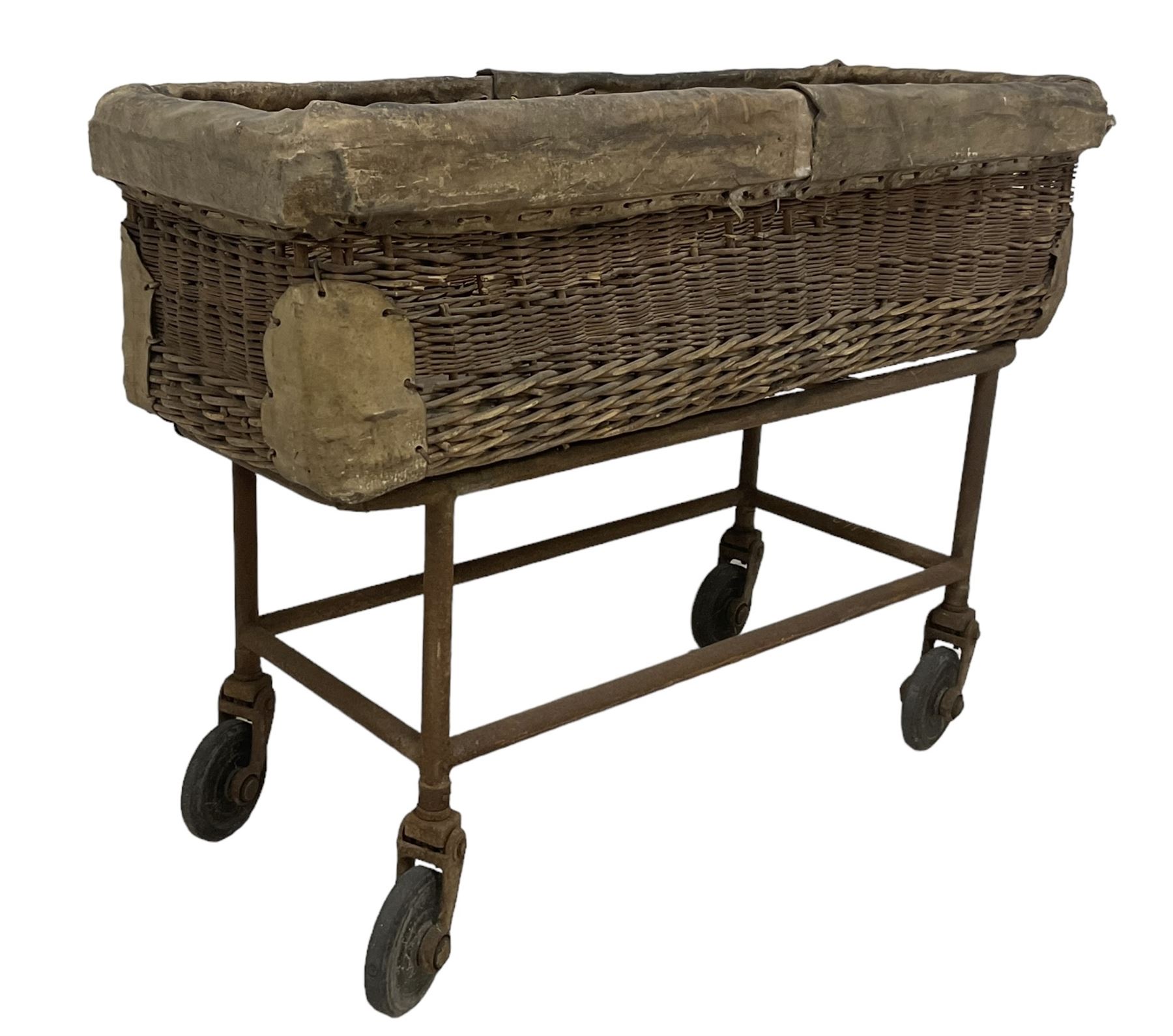 Early 20th century GPO wicker and hide bound postal trolley, on a cast iron base with castors