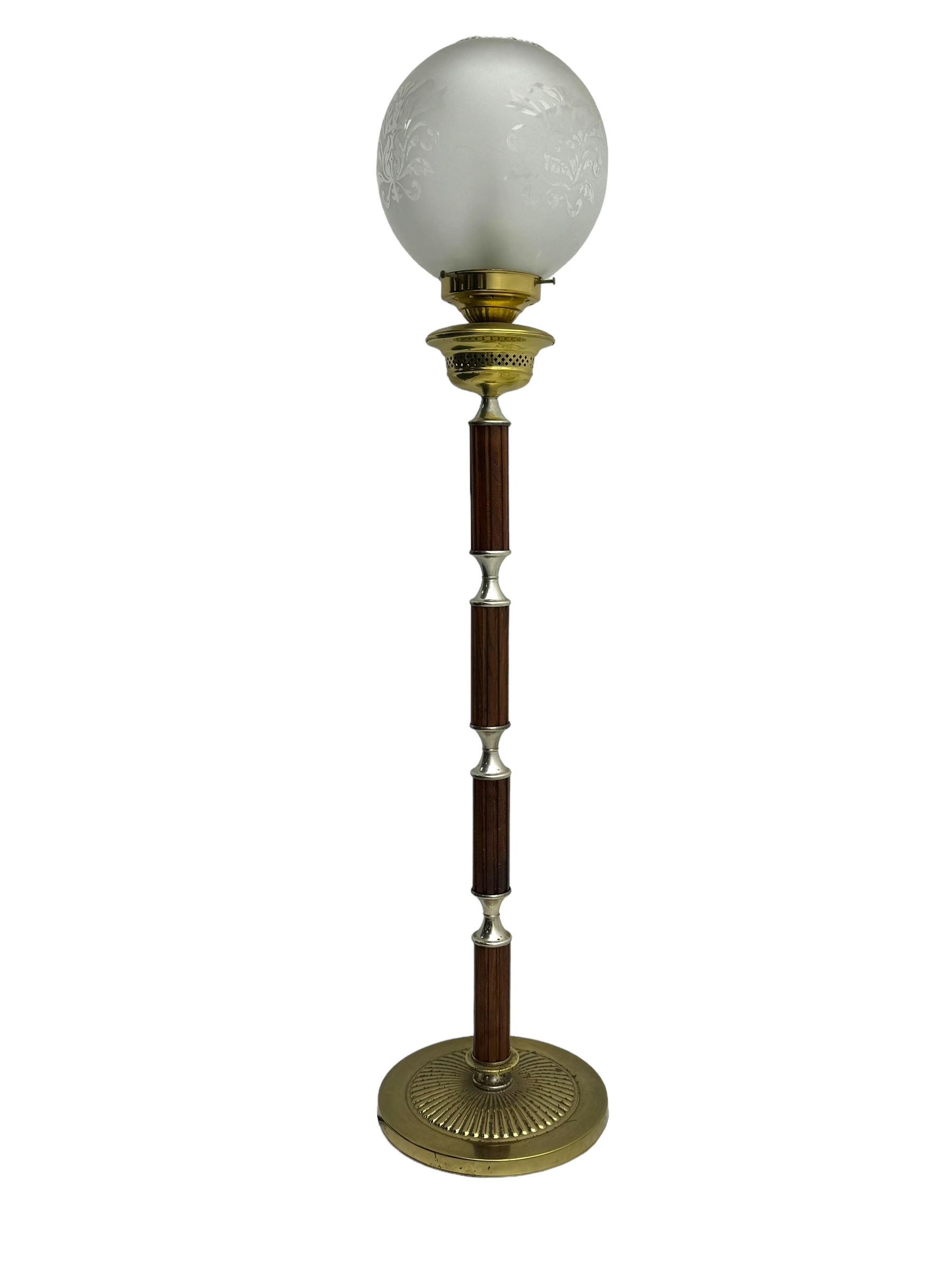 Victorian brass and wood standard lamp, frosted glass globe shade with etched floral design, brass collar above reeded wooden column with metal spacers, on circular brass base with fluted decoration