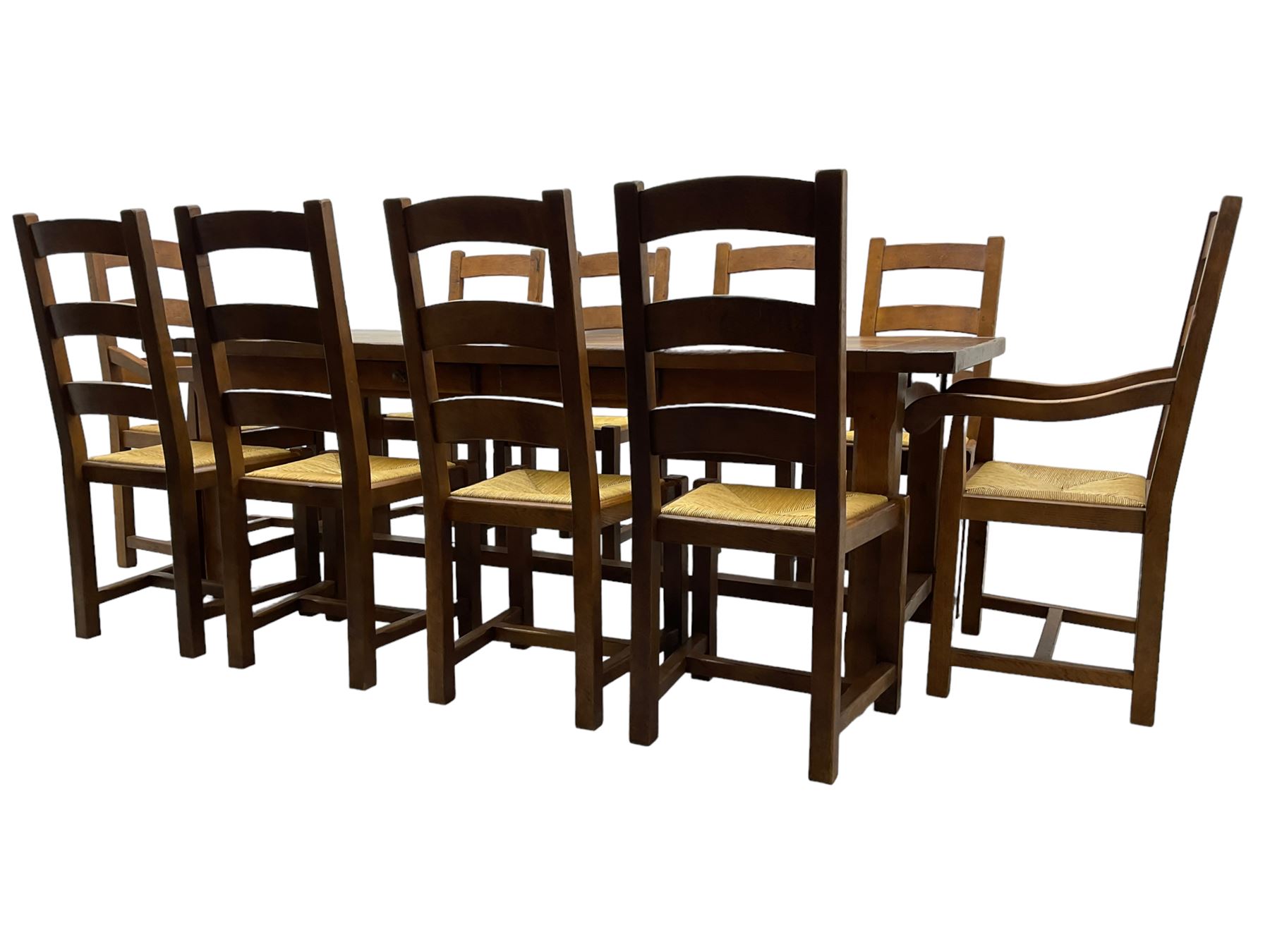 Antix Furniture - oak extending refectory dining table, rectangular plank top with two additional leaves and two drawers to the longer side, on square supports connected by H-stretcher; set of ten (8+2) ladder back dining chairs with rush seats