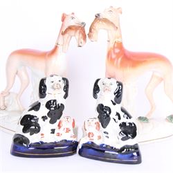 Pair of standing Staffordshire whippets with rabbits in their mouths, together with a pair of Staffordshire spaniels, whippets H30cm