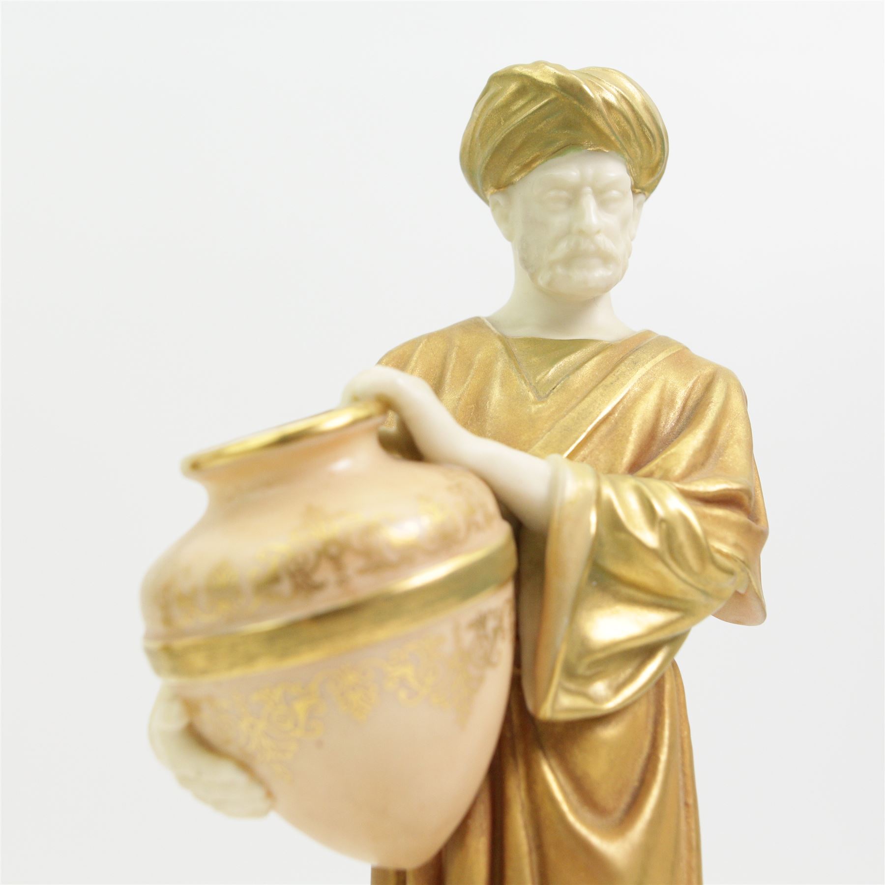 Pair of Royal Worcester figures of Egyptian water carriers after James Hadley dressed in gilt cloaks and on circular bases H24cm, number 1250, date code for 1913