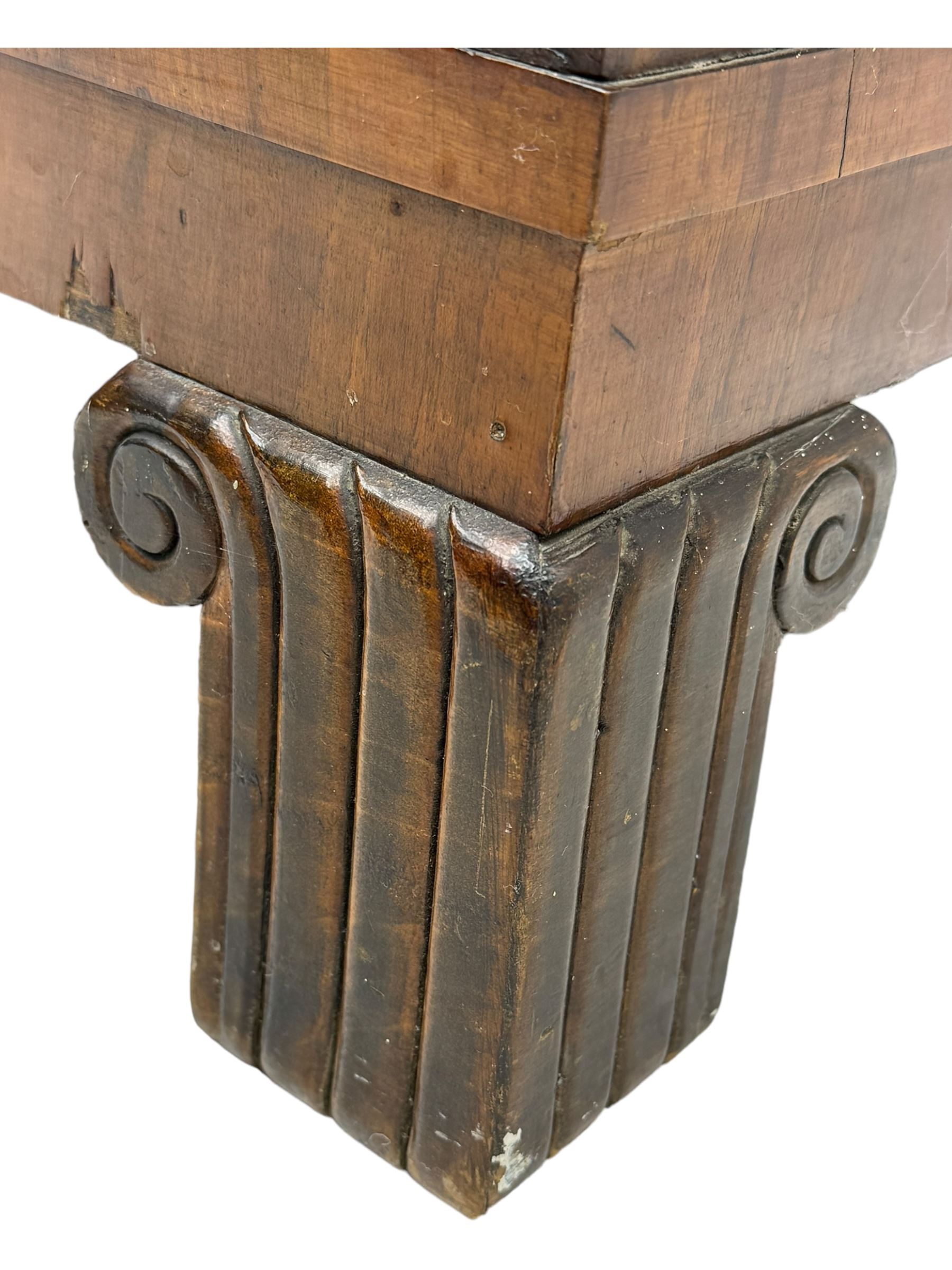 Early 20th century Art Deco walnut display cabinet, with arched top and carved floral crest, central band flanked by two glazed panel doors with decorative mullions, enclosing two glass shelves, on scroll carved bracket feet