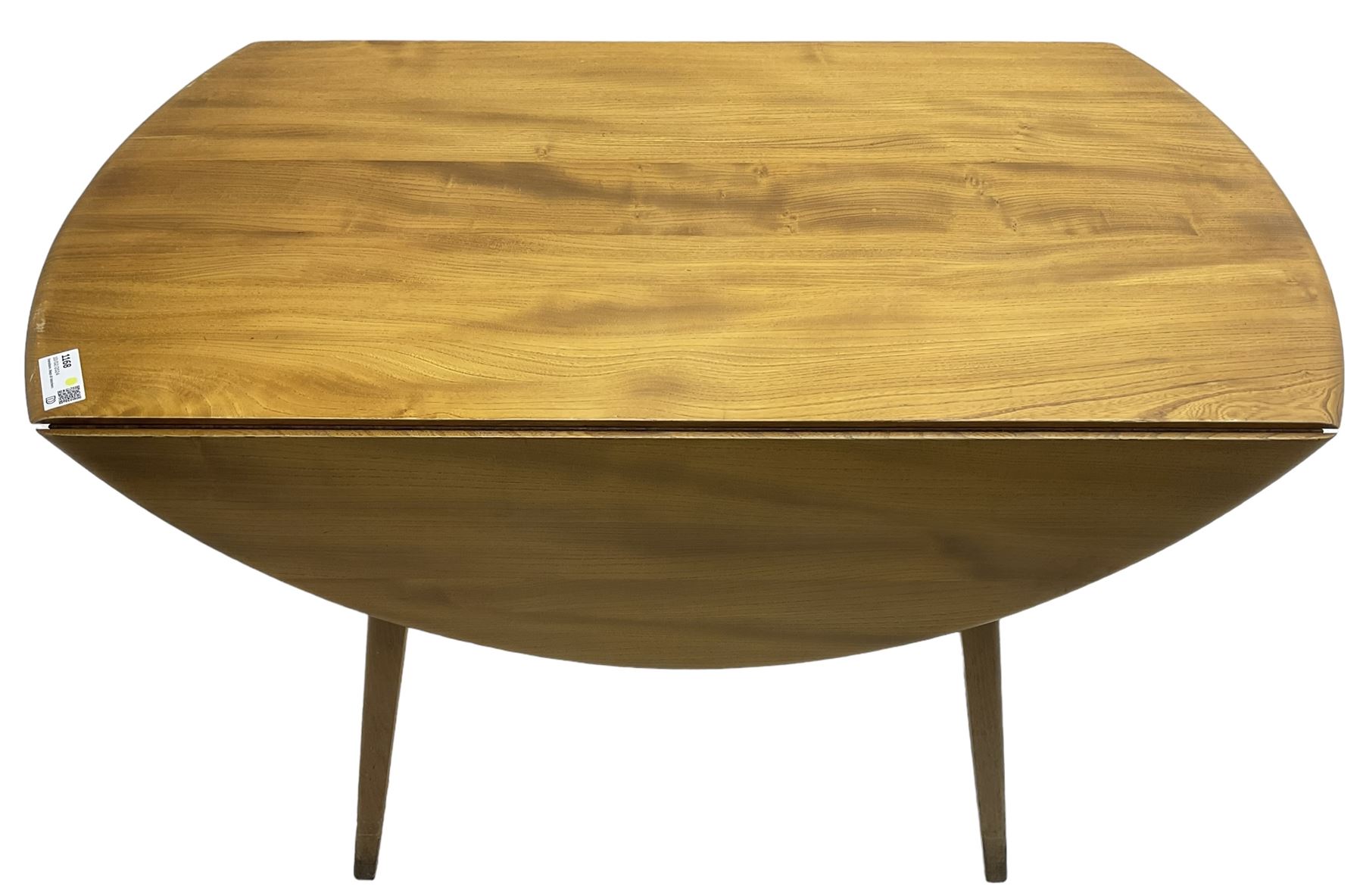 Ercol - mid-20th century golden elm drop-leaf dining table, circular top over splayed supports