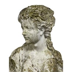 Weathered and painted cast stone garden statue, in the form of an Italian maiden carrying baskets with gathered flora and berries, on a shaped ovoid base