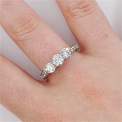 Early 20th century platinum three stone old cut diamond ring, with diamond set shoulders, total diamond weight approx 1.20 carat