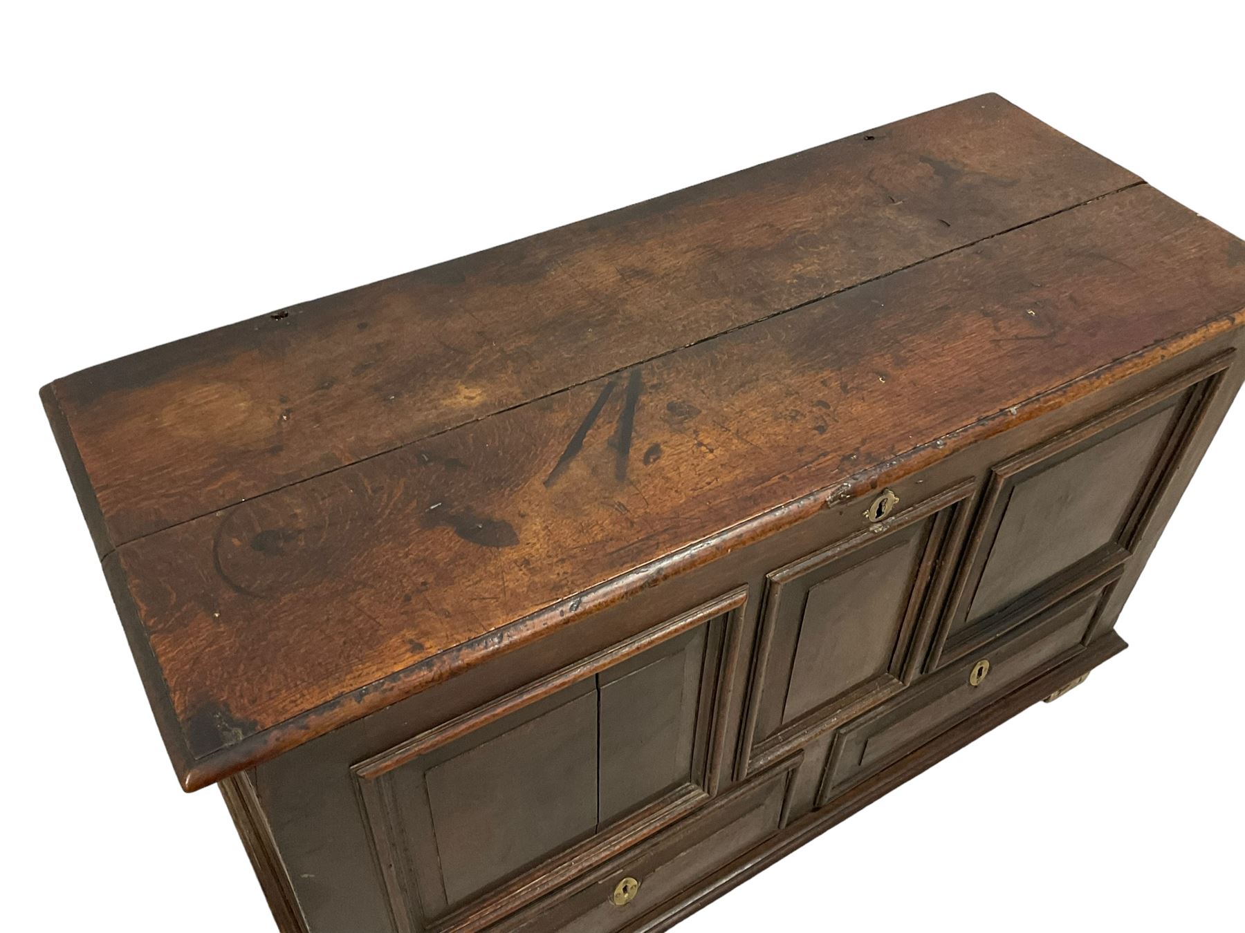 18th century oak mule chest, rectangular hinged top with moulded edge enclosing candle box, triple panelled font over two drawers with fielded panelled facias, on stile supports