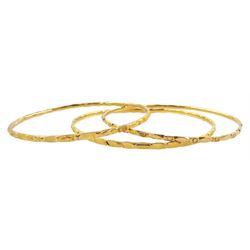 20ct gold Middle Eastern bangle and two similar 19.5ct gold bangles