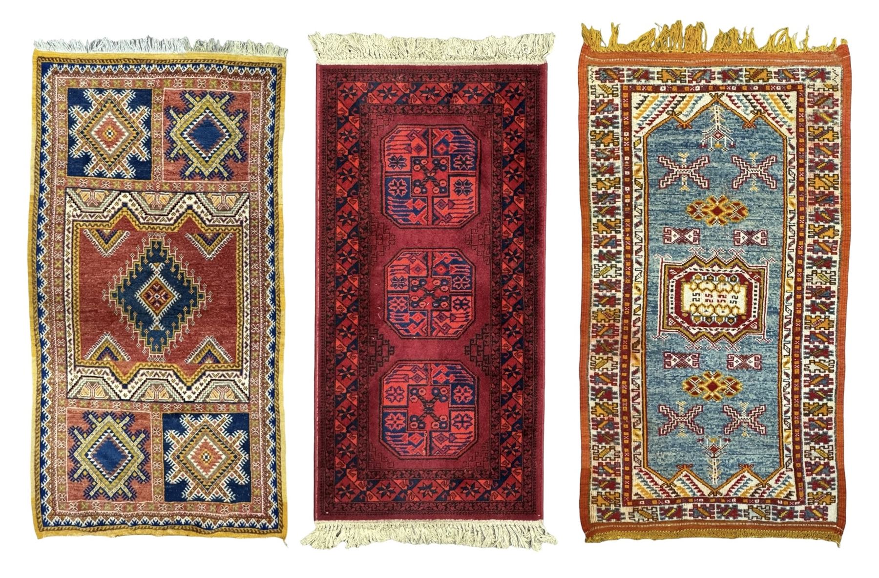 Persian Qashqai crimson ground rug, the field with central indigo and yellow medallion with geometric motifs, flanked by smaller medallions, border with repeating patterns (112cm x 200cm); Turkish Kazak light blue ground rug (109cm x 193cm); red ground runner with three octagonal medallions (69cm x 138cm)