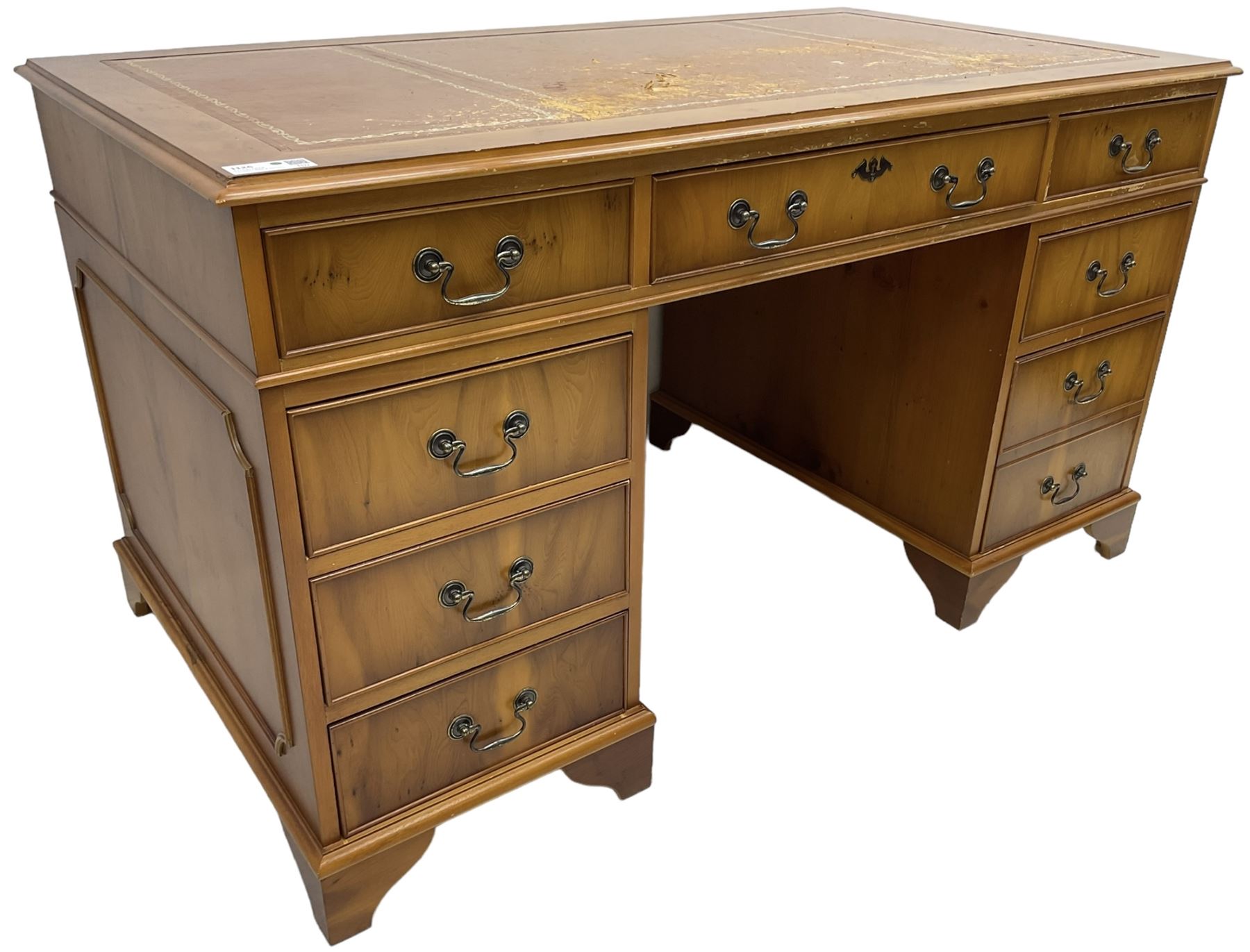 Georgian design yew wood twin pedestal desk, moulded rectangular top over nine cock-beaded drawers, on bracket feet