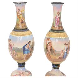 Pair of late 19th century Austrian silver and enamel vases by Hermann Böhm, of baluster form, overall decorated the top depicting musical scenes and oratory with reclining figures in togas, the ovoid bodies painted with Dithyramb scenes portraying Dionysiac worshippers playing the cymbals, pan pipes and lyre, with a dancing Maenad bearing a Thyrsus beside, and surrounding figures consuming wine, the domed pedestal feet depicting the Greek gods observing from the clouds with Putti, and recovering a lost statue from ploughed fields, within foliate silver mounts, marked A for Vienna and maker's mark HB, H21cm (2)