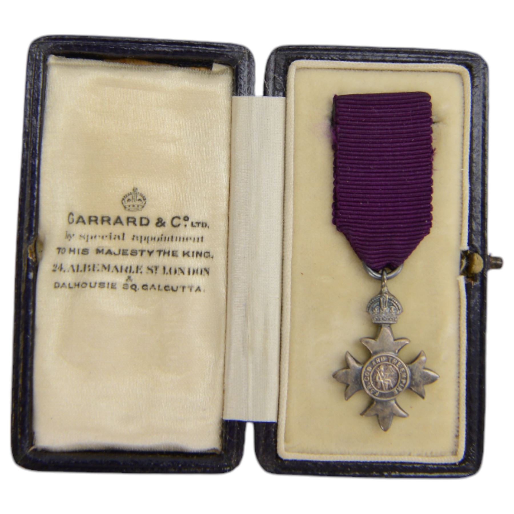 The Most Excellent Order of the British Empire, George V, M.B.E. breast badge, silver-gilt, hallmarked Garrard & Co Ltd, London, housed in an M.B.E. case, together with matching miniature in case, attributed to Joseph Percival Sykes  