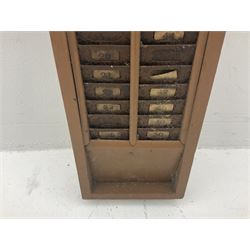 Late 19th/early 20th century wall mounted painted wood and iron clocking in machine card rack, L90cm