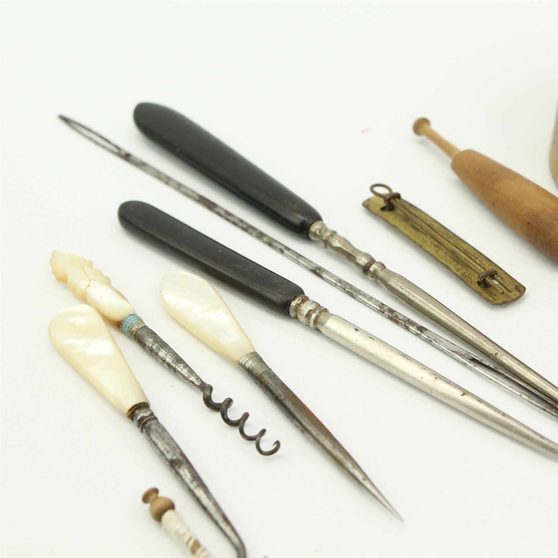 19th century and later lace maker's bone and turned wooden bobbins with glass spangles, pins, patterns, five cushions, related book and other accessories 