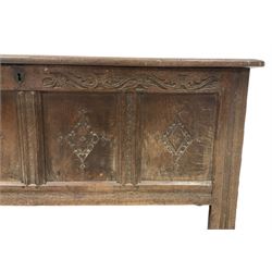 18th century oak coffer or chest, rectangular hinged panelled top with moulded frame enclosing candle box, the frieze carved with foliate S-scrolls over a quadruple panel front decorated with carved lozenges, on stile supports