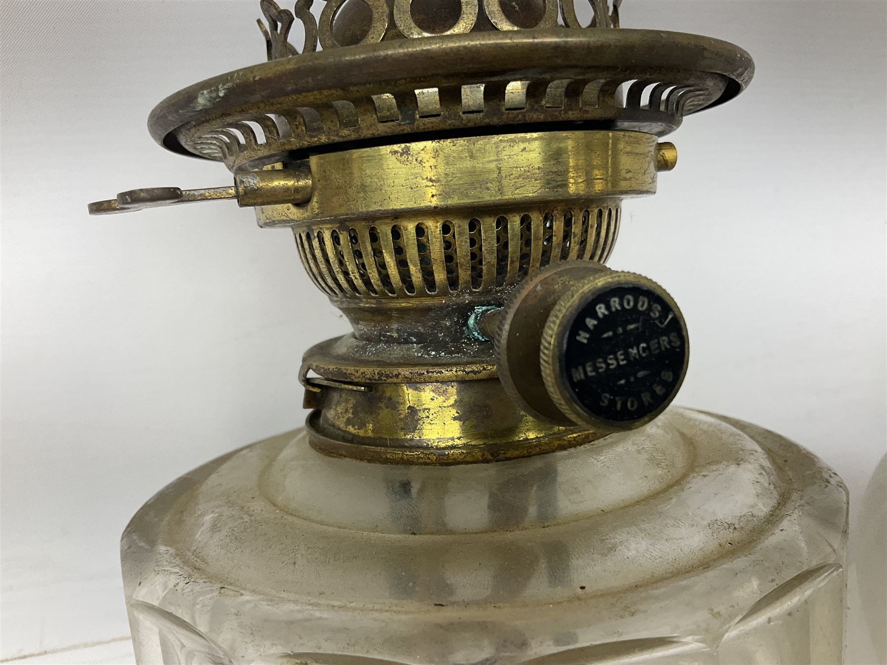 Victorian brass oil lamp converted to electricity, the square stepped base with a reeded doric column leading to a cut clear glass reservoir and burner and spherical shade with printed bird decoration, together with another similar shade and oil lamp parts and accessories etc