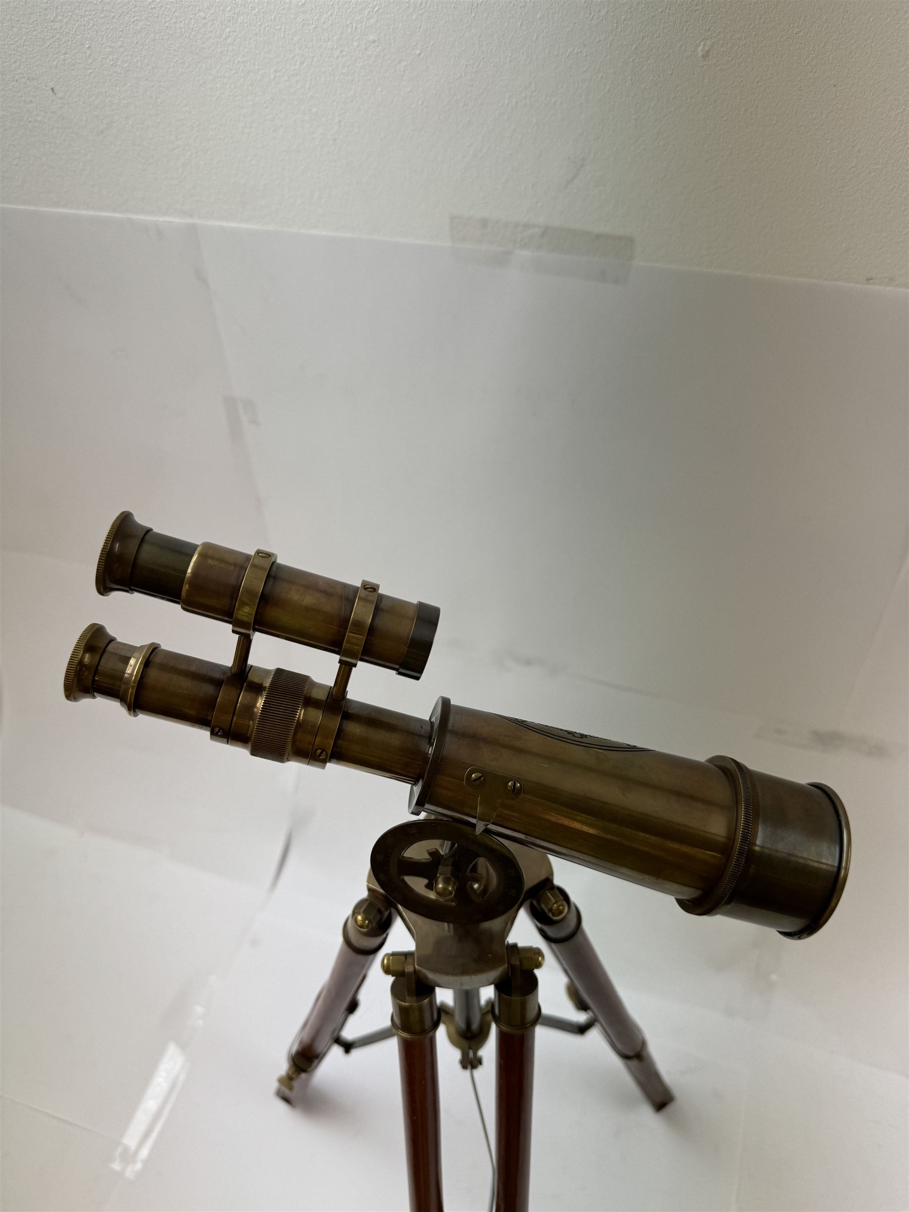 Brass telescope upon a wooden adjustable tripod, H55cm 