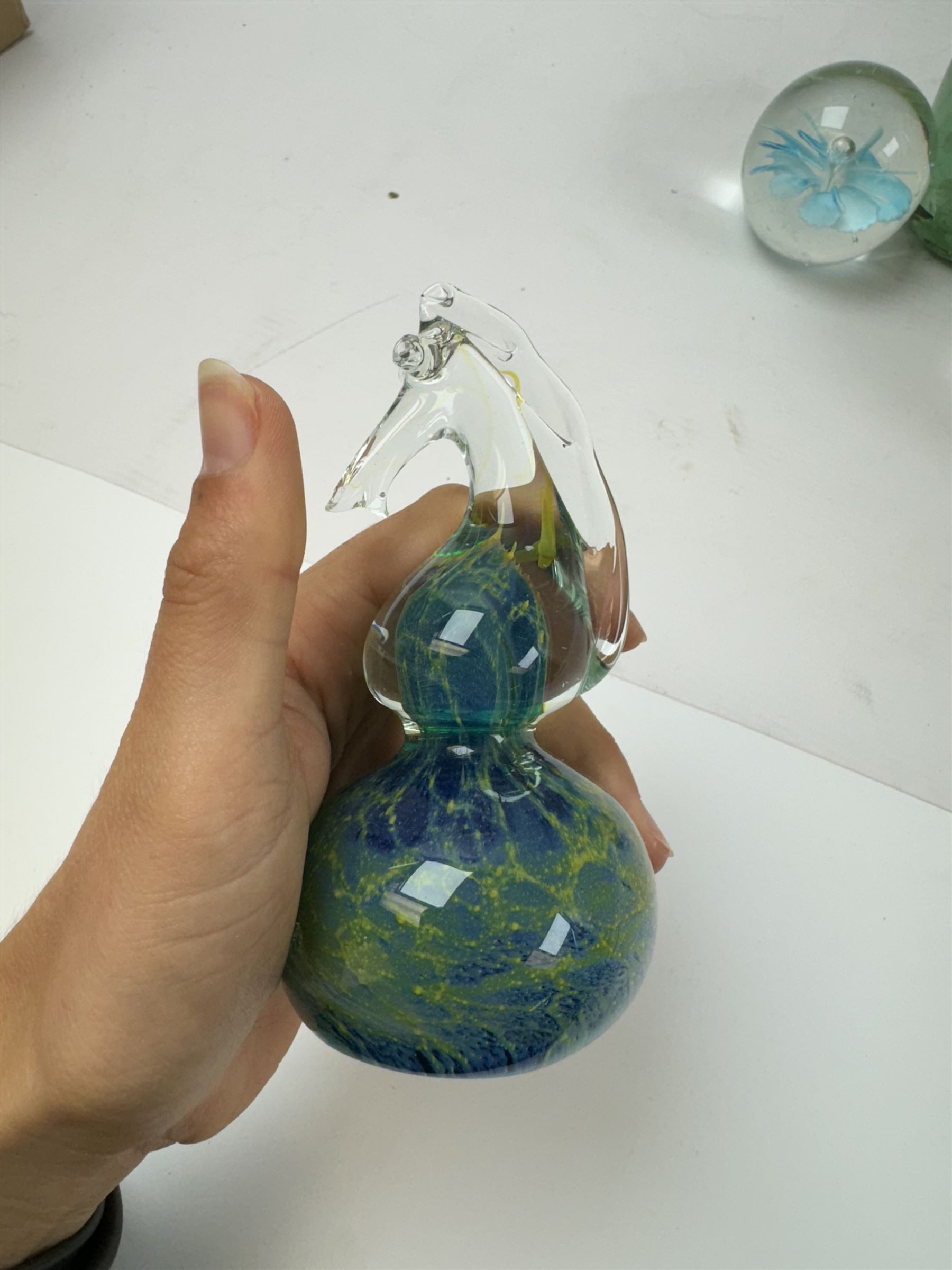 Two glass dump paperweights, with flower inclusions, together with four further glass paperweights