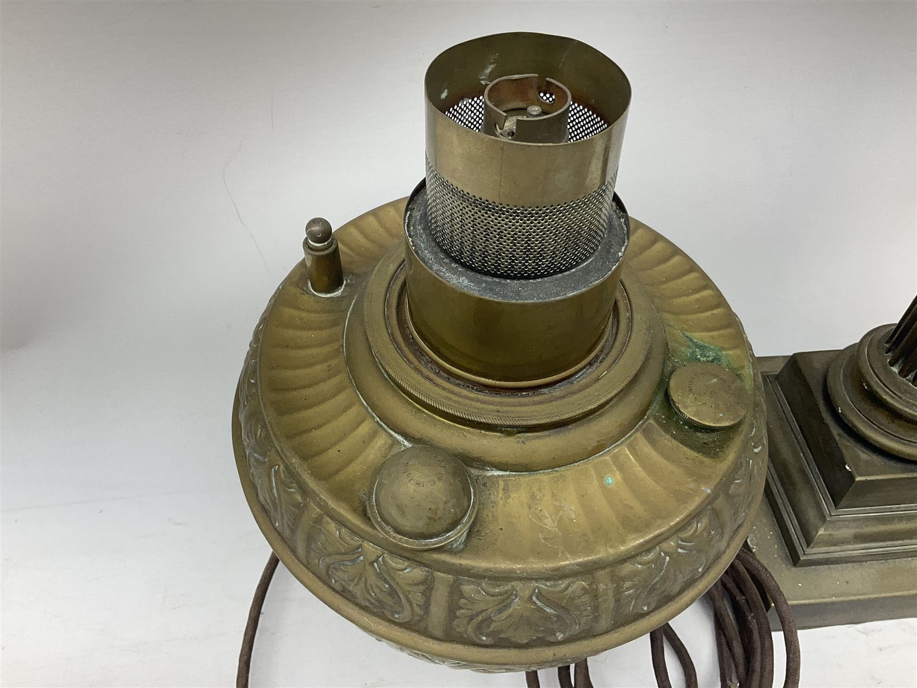 Victorian brass oil lamp converted to electricity, the square stepped base with a reeded doric column leading to a cut clear glass reservoir and burner and spherical shade with printed bird decoration, together with another similar shade and oil lamp parts and accessories etc