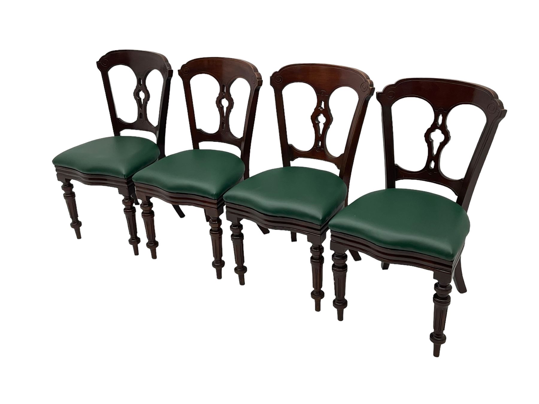 Matched set of twelve Victorian mahogany dining or boardroom chairs, the shaped cresting rail decorated with scrolled decoration, upholstered drop-on seats upholstered in green fabric, on turned supports  