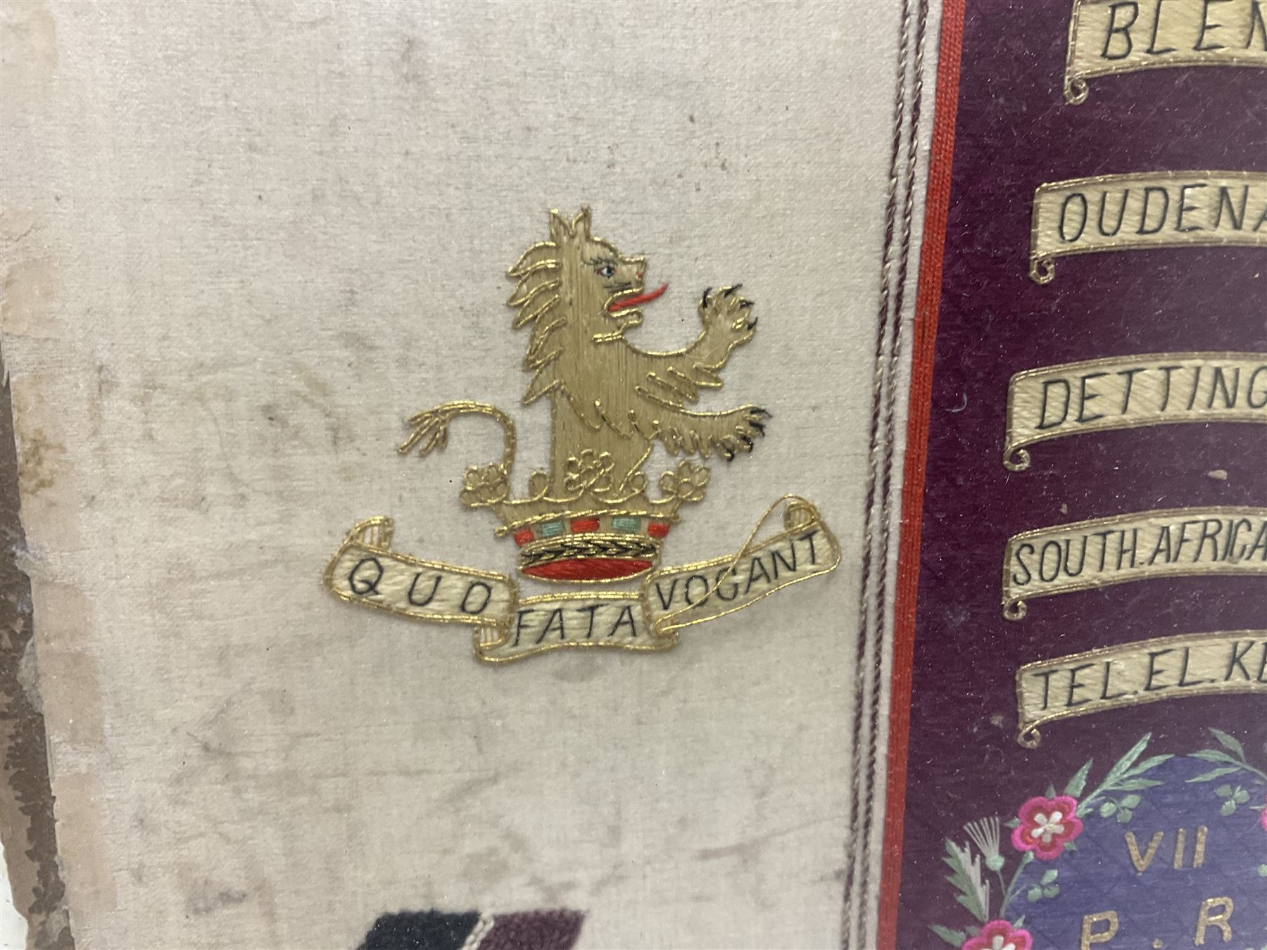 Commemorative Military needlework, headed 'VII Princess Royal's Dragoons Guard, the central flag has the regimental title, surrounded by a Union wreath of roses, thistles and shamrocks, topped with a crown, the Hanoverian white horse features in two corners, framed H58cm, L73cm