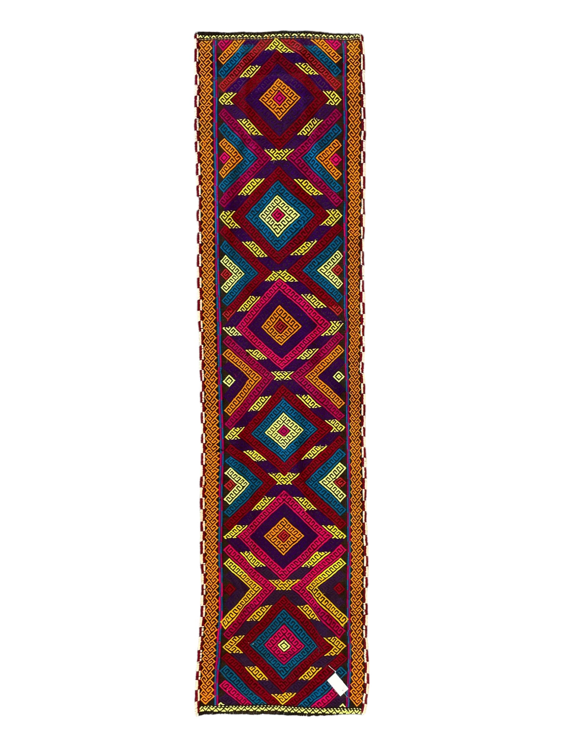 Flatweave geometric design runner rug, decorated with trailing lozenges decorated with hooked motifs, within zig-zag bands, bright multi-coloured ground 