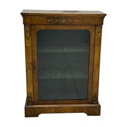 Late Victorian walnut pier cabinet, projecting cornice over frieze inlaid with foliate motifs, single glazed door flanked by ormolu mounts, enclosing shelved interior, on plinth base