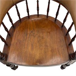 Pair of late Victorian walnut tub-shaped elbow chairs, the cushioned cresting rail upholstered in leather on spindle turned supports, dished saddle seat on turned supports