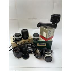 Canon T60 camera body serial no 25230455 together with a collection of Canon camera accessories, including zoom lenses, bellows, etc 