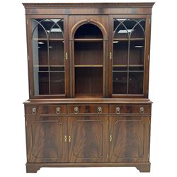 Georgian design mahogany bookcase on cupboard, projecting moulded and dentil cornice, two display cabinets enclosed by glazed doors above over three drawers and three cupboards, on bracket feet