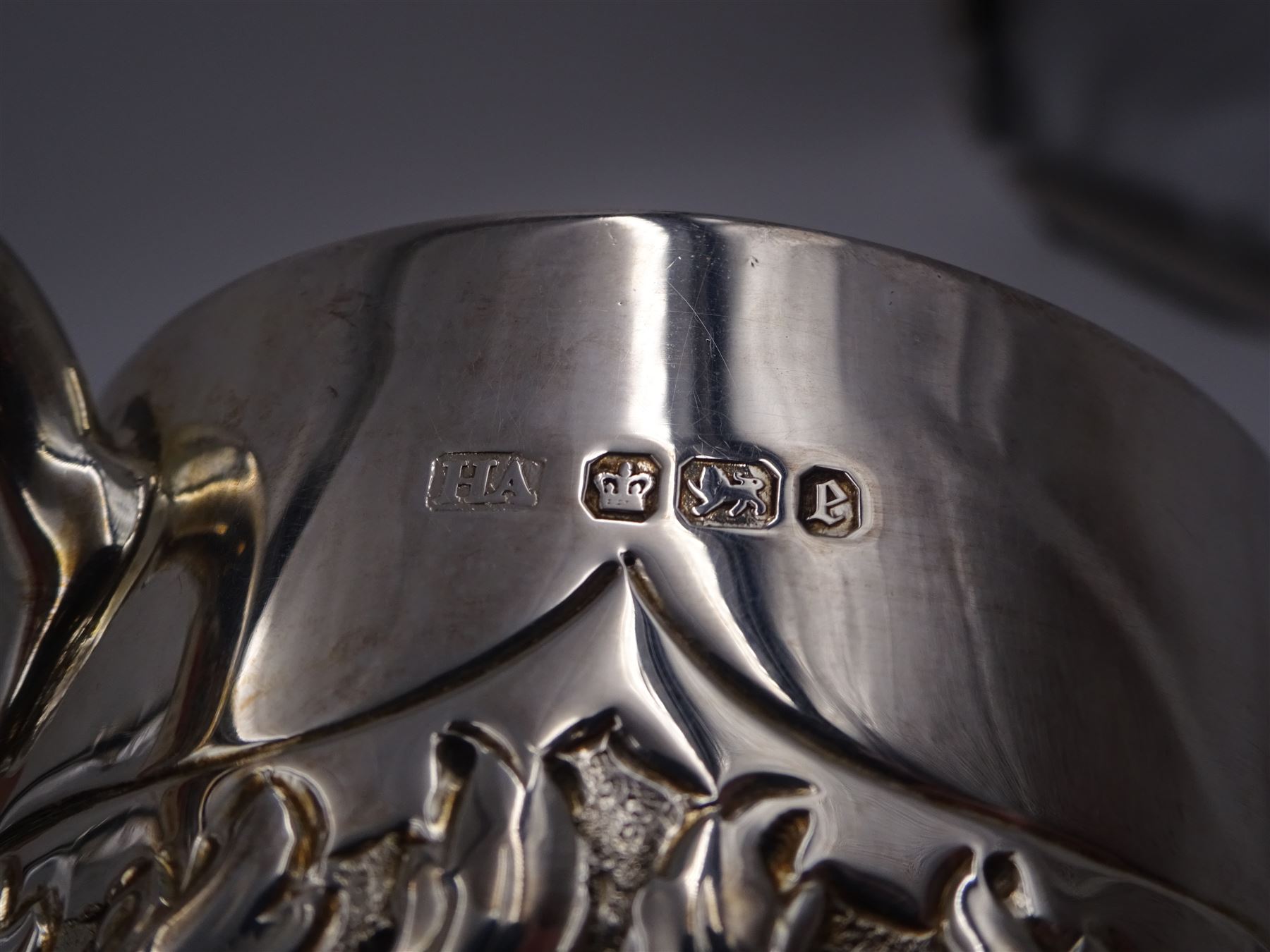 Late Victorian silver christening mug, with C handle and gilt interior, the body profusely embossed with floral and foliate decoration, hallmarked Atkin Brothers, Sheffield 1897, H10cm