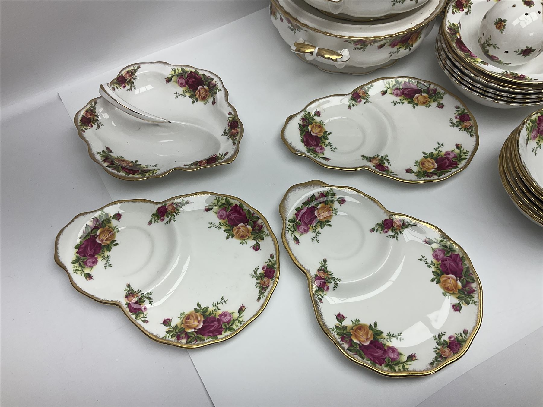 Royal Albert Old Country Roses pattern part tea and dinner service, to include two tureens, eight dinner plates, six side plates, twelve bowls, two mugs, seven teacups and saucers, milk jug,  twelve cake plates, six soup bowls and saucers, candlesticks, etc (95)