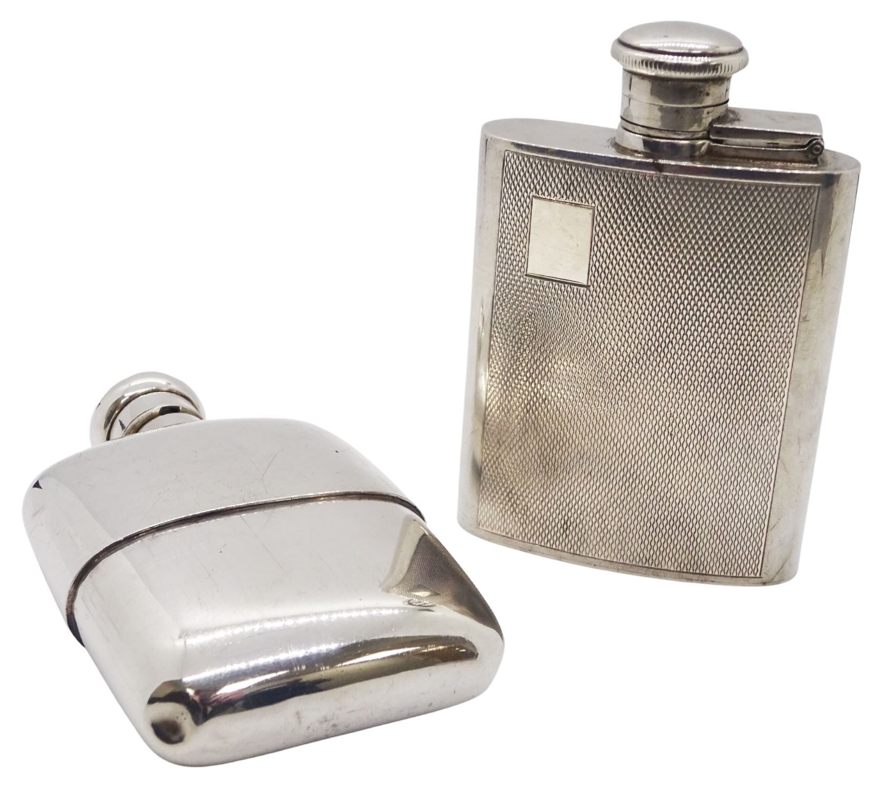 Modern silver hipflask, with engine turned panel to front and vacant rectangular panel to upper left corner, hallmarked William Manton, Birmingham 1989, H9.5cm, together with another modern silver hipflask hallmarked London import, 1990, makers mark indistinct, H10cm, approximate total weight 6.97 ozt (217 grams)