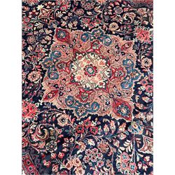 Persian Mahal indigo ground carpet, floral medallion on a field of swirling leafy branches and flower heads, shaped ivory field band decorated with flower head bouquets and trailing branches, the border decorated with floral motifs, within guard stripes