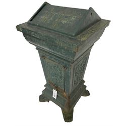 Early 20th century cast iron litter bin, square tapering form with scrolling foliate decoration, on paw feet