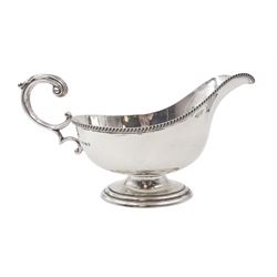 1930s silver sauce boat, of typical form, with oblique gadrooned rim and acanthus capped flying C scroll handle, by William Hutton & Sons Ltd, Sheffield 1934, H11cm