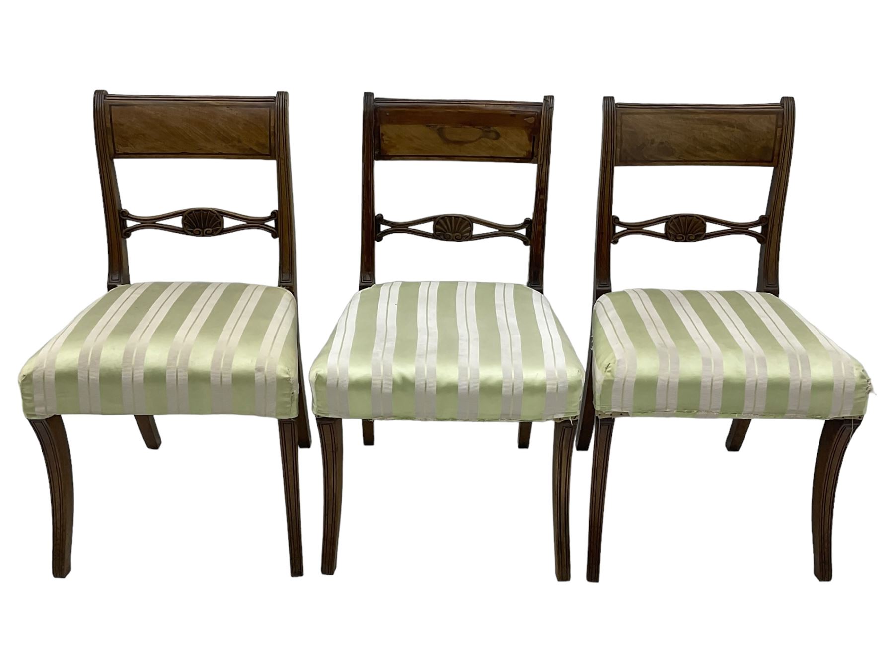 Set of six early 19th century mahogany dining chairs, bar cresting rail over pierced and shell carved middle rail, reed moulded uprights, upholstered seats on reed moulded sabre supports 