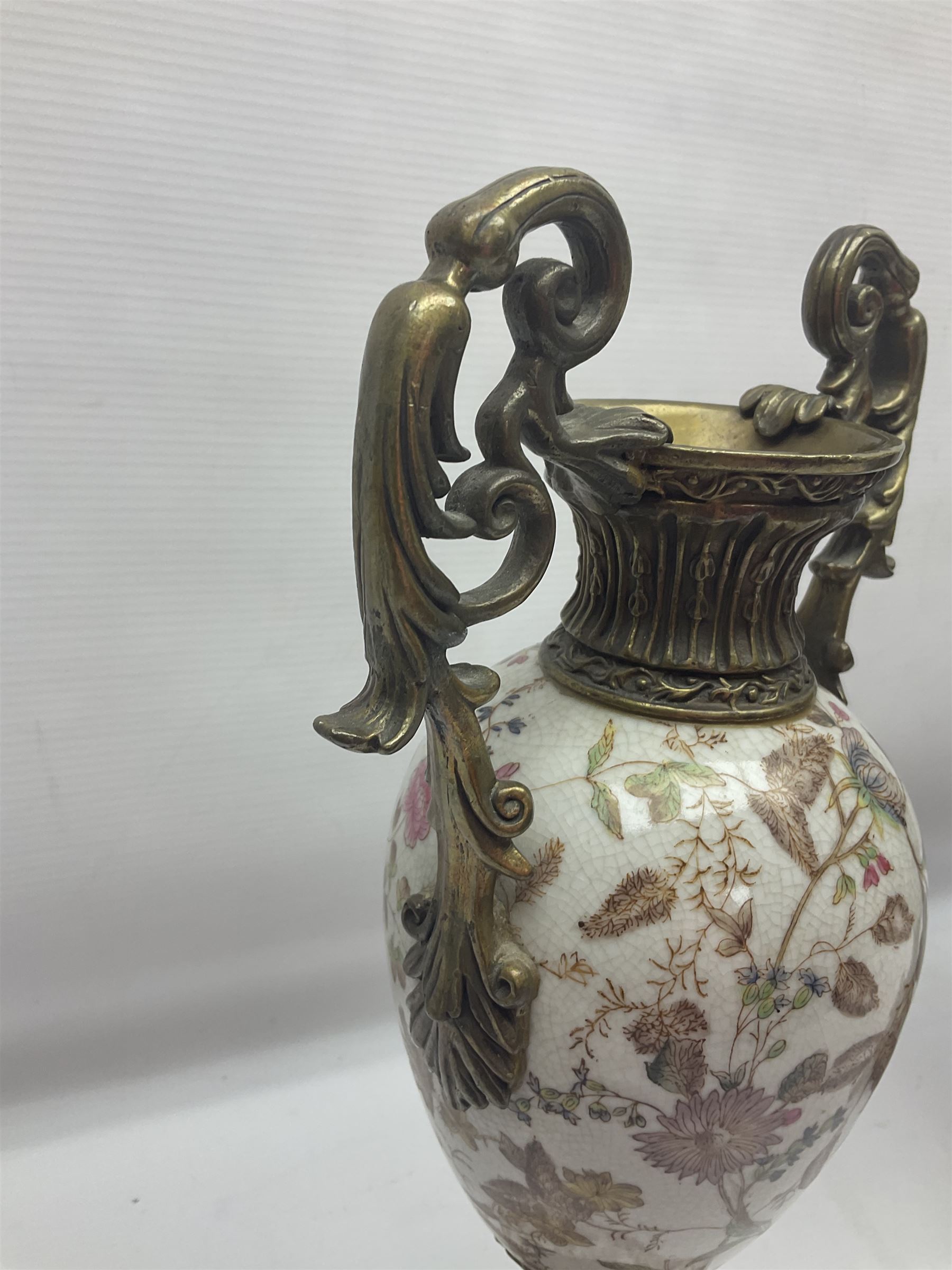 Wong Lee, twin handled ceramic urn with enamelled floral decoration and bronzed metal mounts, upon a square base, marked to base, together with similar twin handled urn with enamelled Cherub decoration, largest H44cm