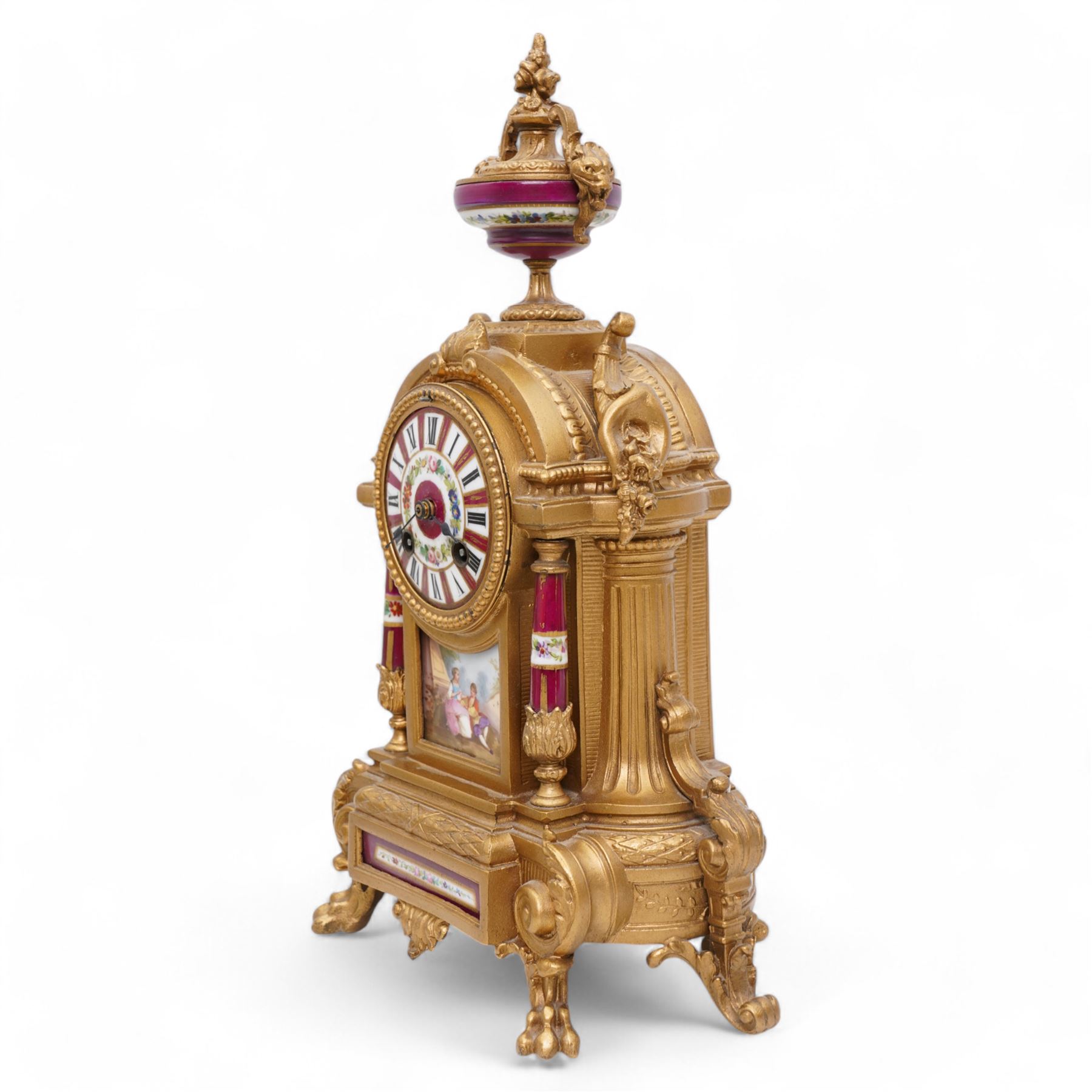 French - Late 19th century 8-day gilt metal and porcelain mounted clock c1880, the arched case above a plinth base on paw feet surmounted by an urn, porcelain dial with cartouche Roman numerals and steel spade hands, twin train rack striking movement, sounding the hours and half hours on a bell. With pendulum. 