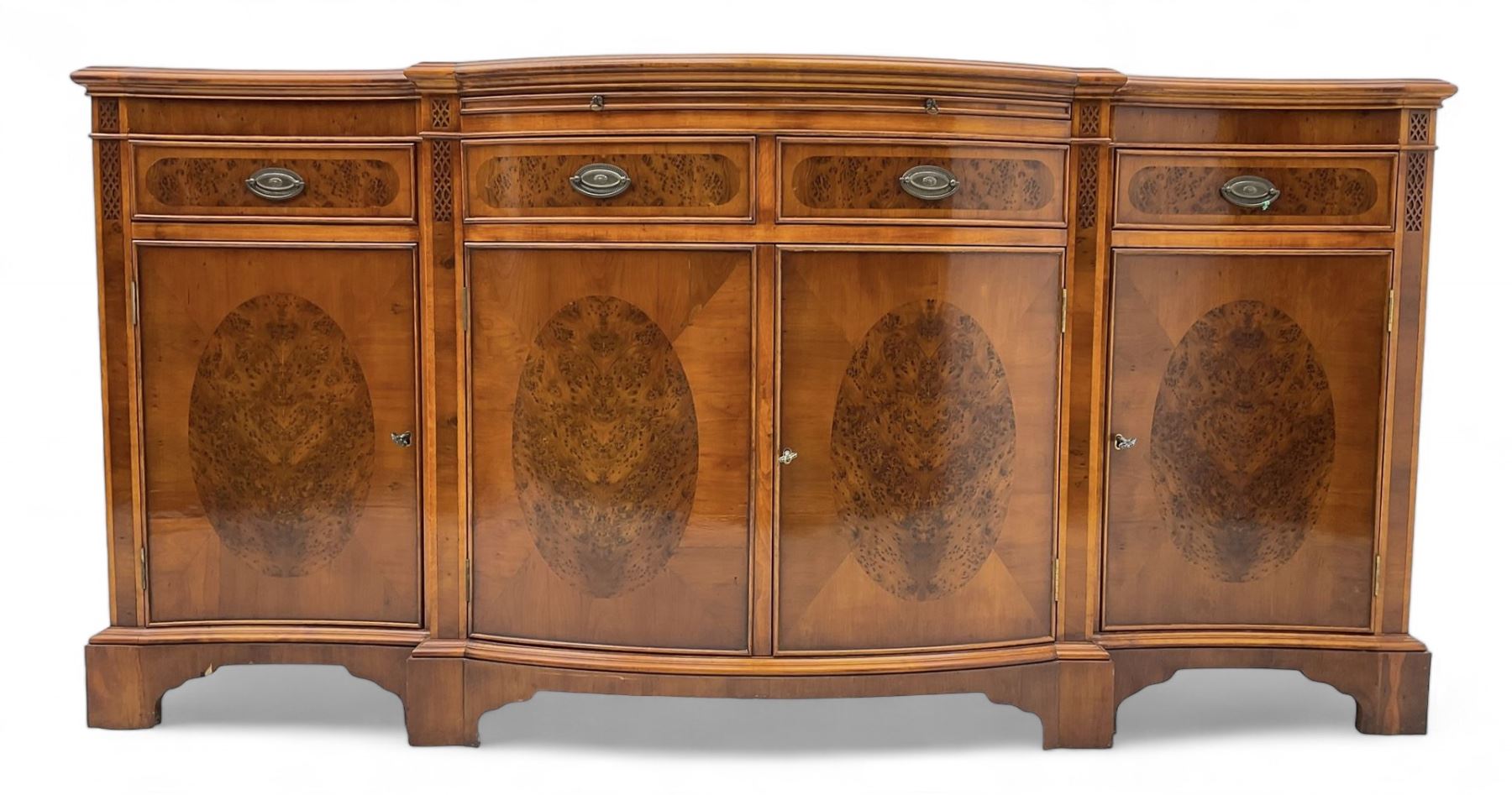 Wade - Georgian design yew wood bow-fronted sideboard, projecting moulded top over four cockbeaded frieze drawers, the central two with pull-out slides, four cupboards below with figured veneers, raised on bracket feet