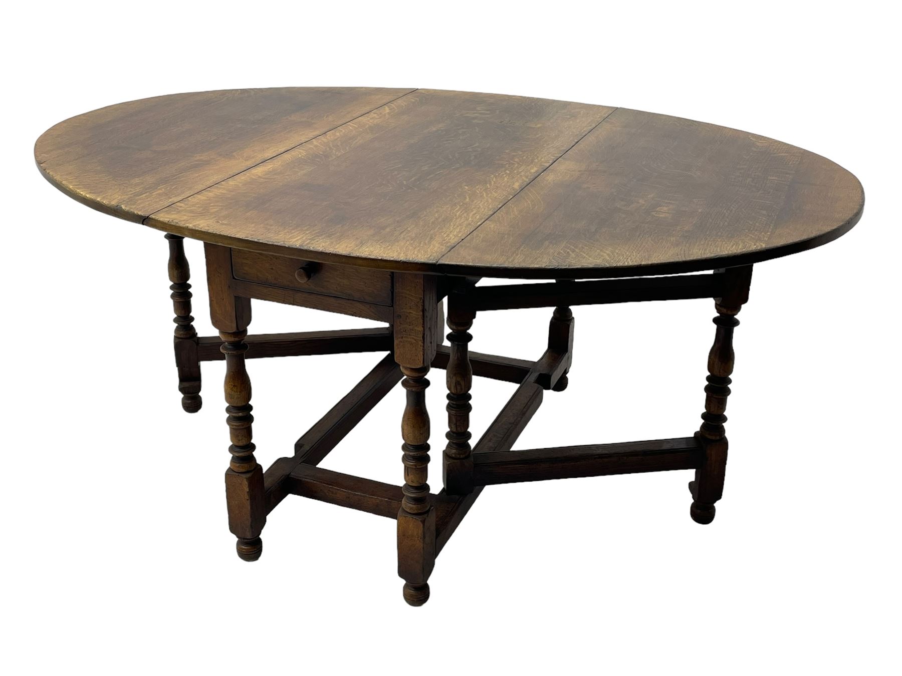 18th century oak dining table, oval drop-leaf top on gate-leg action base, turned supports united by turned stretchers, fitted with single end drawer