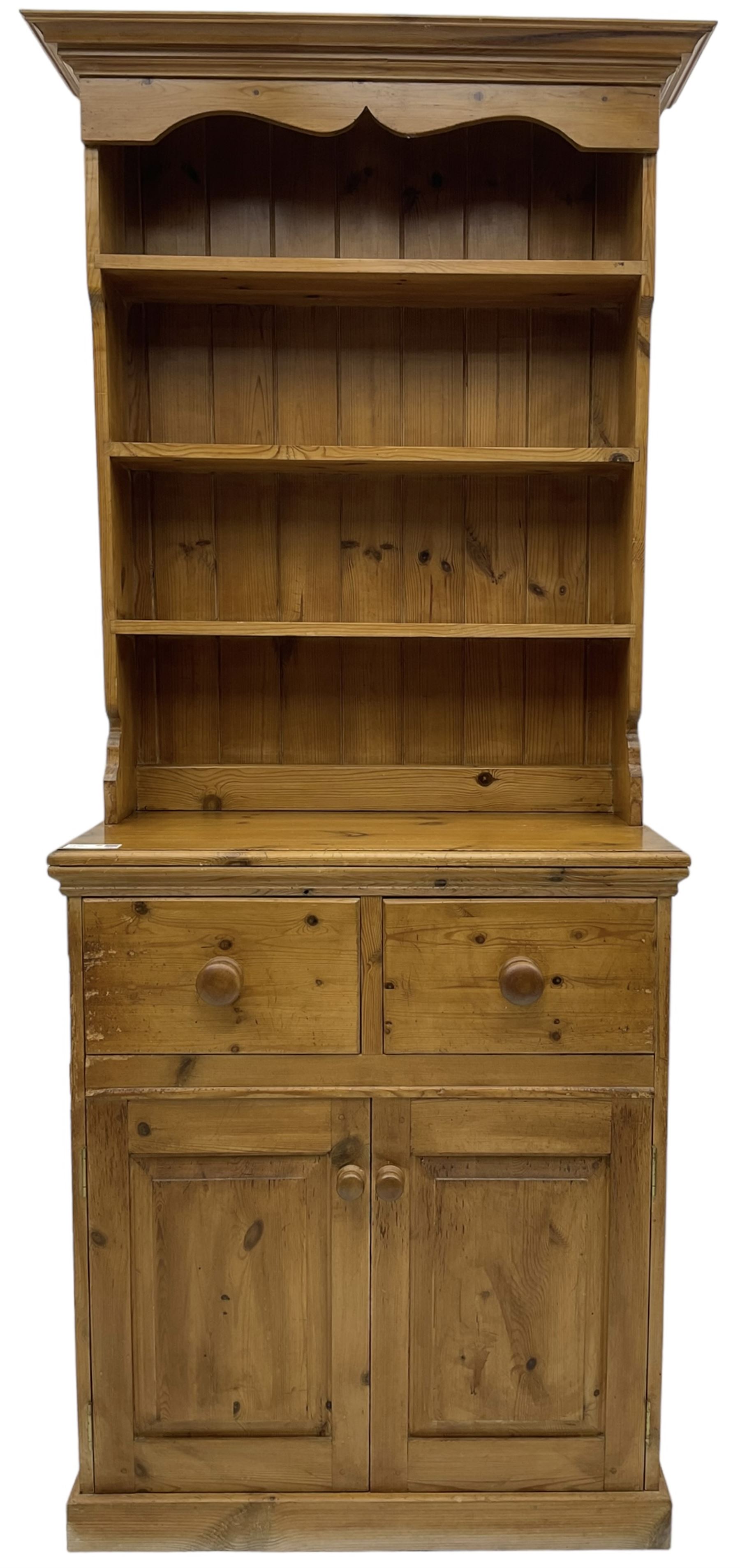 Solid pine dresser, fitted with plate rack above two drawers and two cupboards