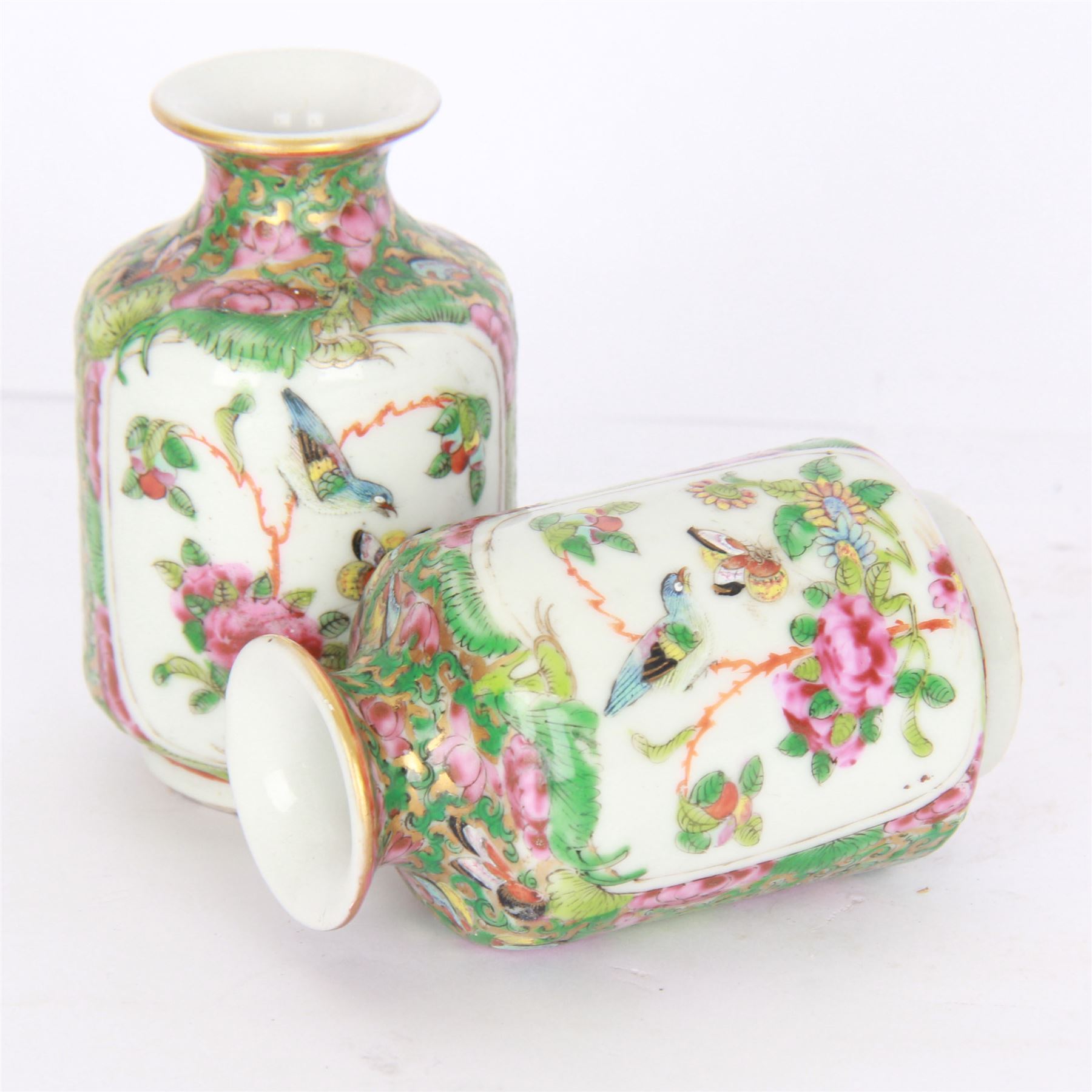 Pair of Chinese famille rose miniature vases, painted with panels depicting figures in a garden, with flora and fauna decoration, H10cm