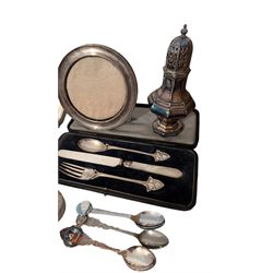 Silver photograph frame and a silver mustard spoon, both hallmarked, together with an Egyptian silver box, silver plated Walker & Hall christening set, silver plated sugar caster, silver plated coffee bean spoons, and silver plated pepper and salt shaker