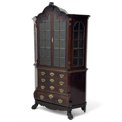 19th century Dutch mahogany vitrine on chest, shaped moulded pediment with central C-scroll and flowerhead carved mount, enclosed by two astragal glazed doors, the interior fitted with fabric lined shelves, four graduating long drawers below, on ball and claw carved feet 