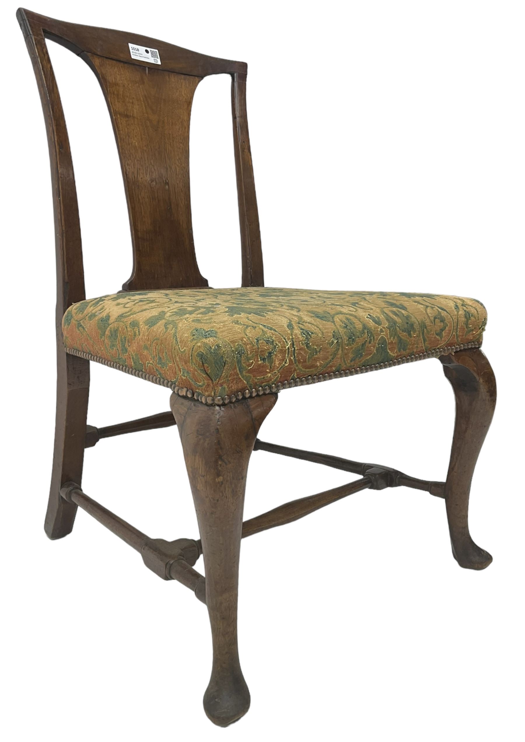 Mid-18th century mahogany side chair, shaped cresting rail over tapered back splat, seat upholstered in green and camel foliate patterned fabric with stud work border, raised on cabriole supports united by swell-turned stretchers