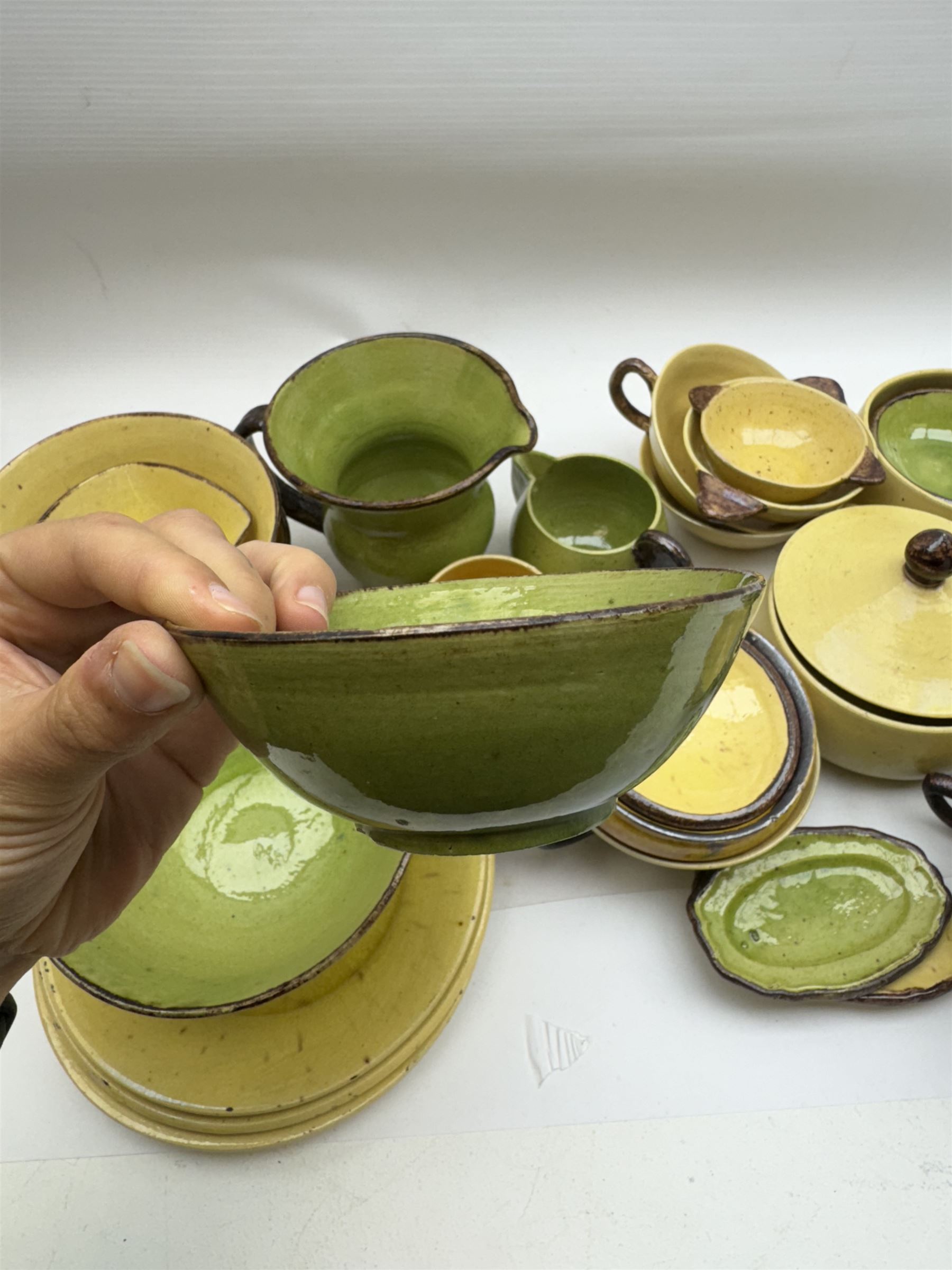 French green and yellow glazed tea and dinner wares by Etienne Noel, including milk jugs, teacups, side plates, bowls etc (43)